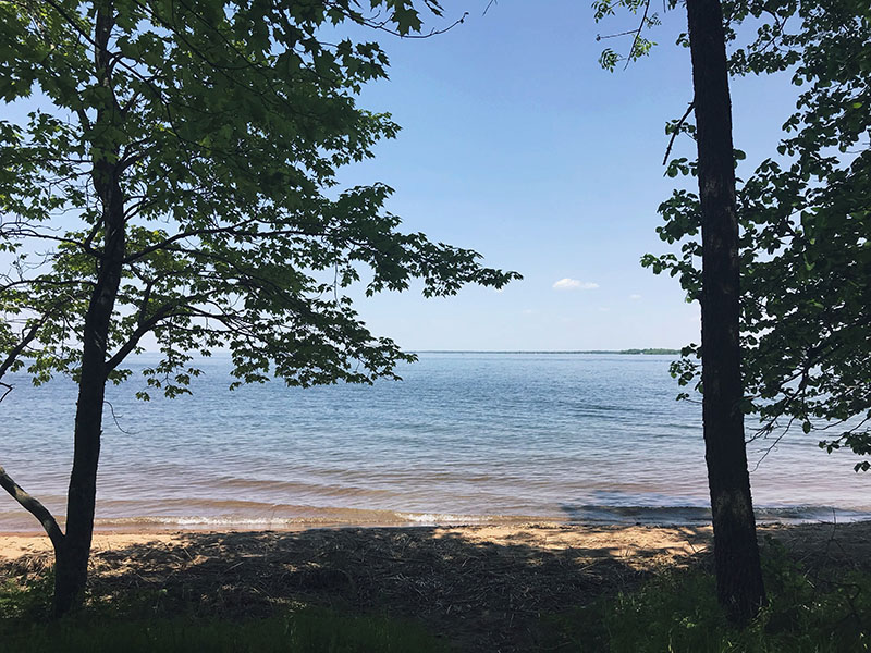 Shaded swimming beach at Father Hennepin State Park.