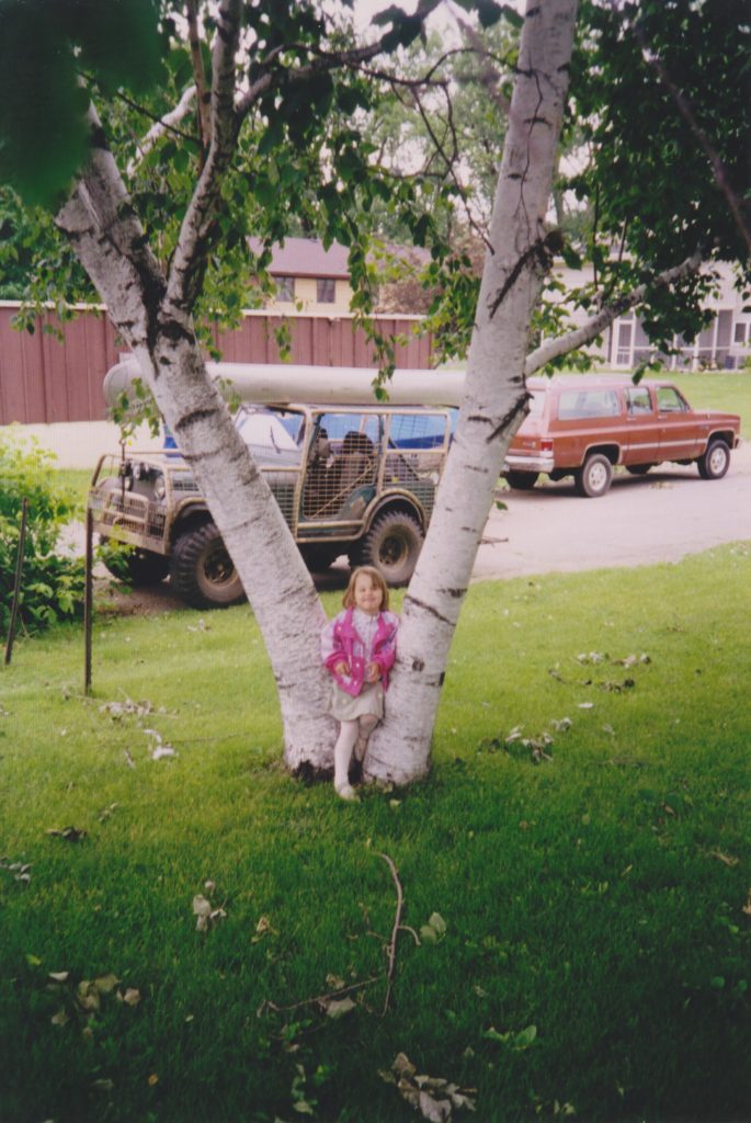 Little four year old Ana in front of the birch tree.